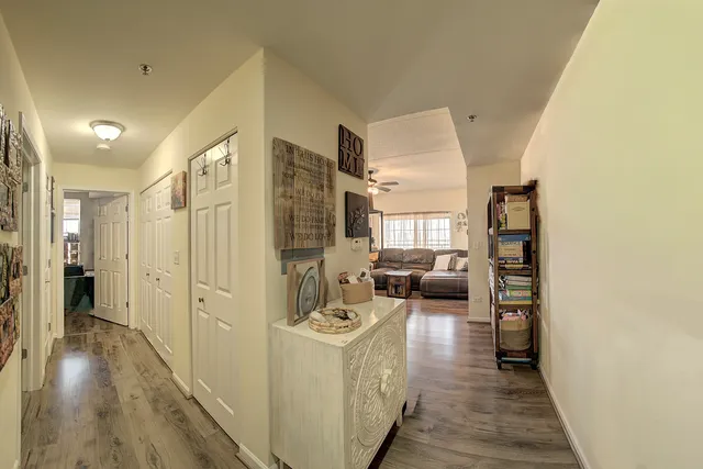 a view of a hallway view with wooden floor and furniture