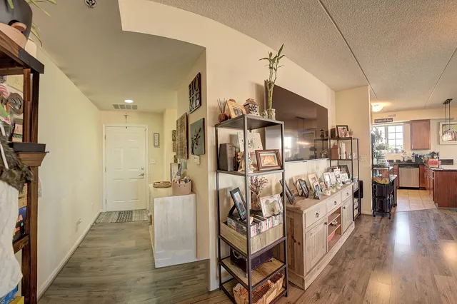 a spacious bedroom with a bed and a wooden floor