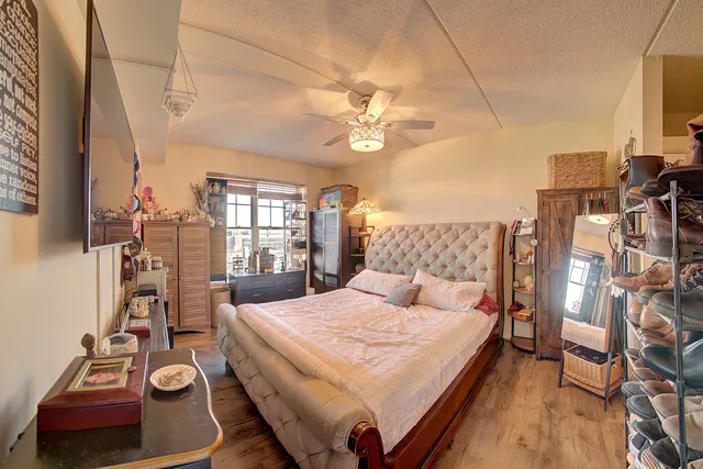 a bedroom with a bed and a chandelier