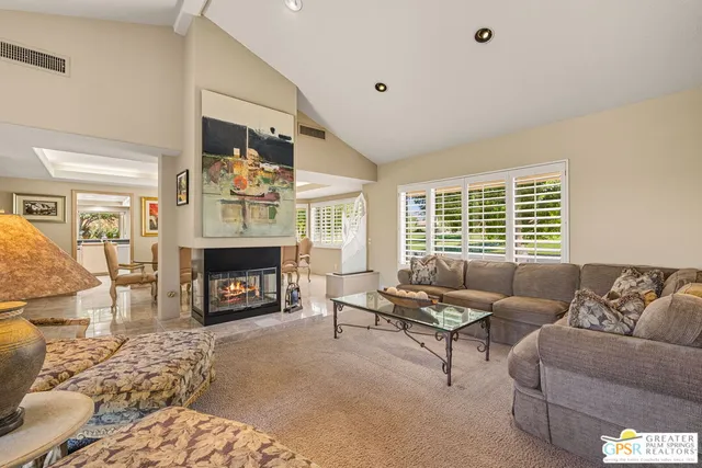 a dining room with furniture a rug and a large window