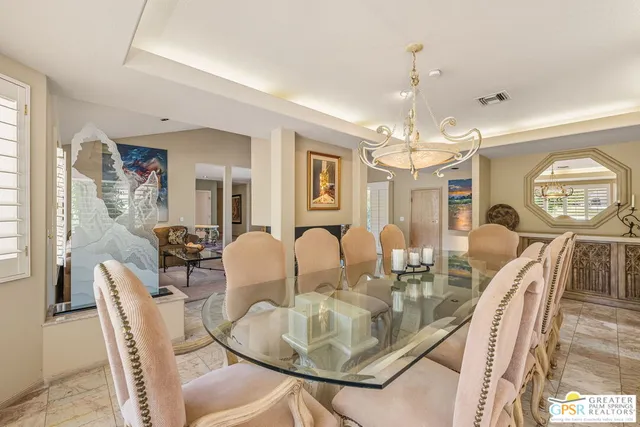 a view of a patio with table and chairs with wooden floor and fence