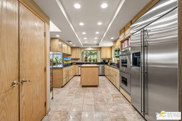 a view of a backyard with plants and a patio