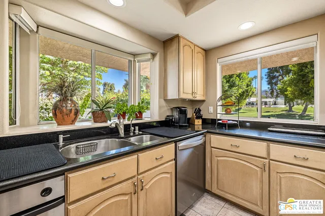 a front view of a house with yard and swimming pool