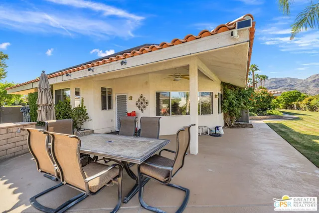 a living room with furniture a flat screen tv and a window