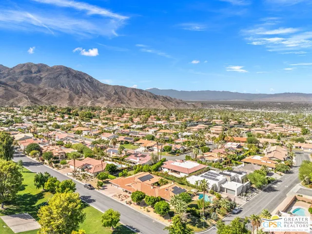 a view of a patio with couches and table and chairs with potted plants