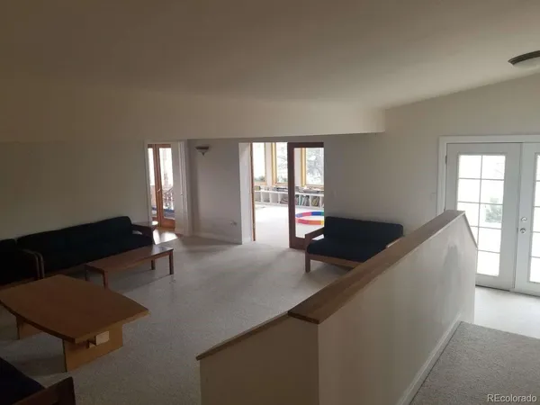 a living room with furniture window and wooden floor