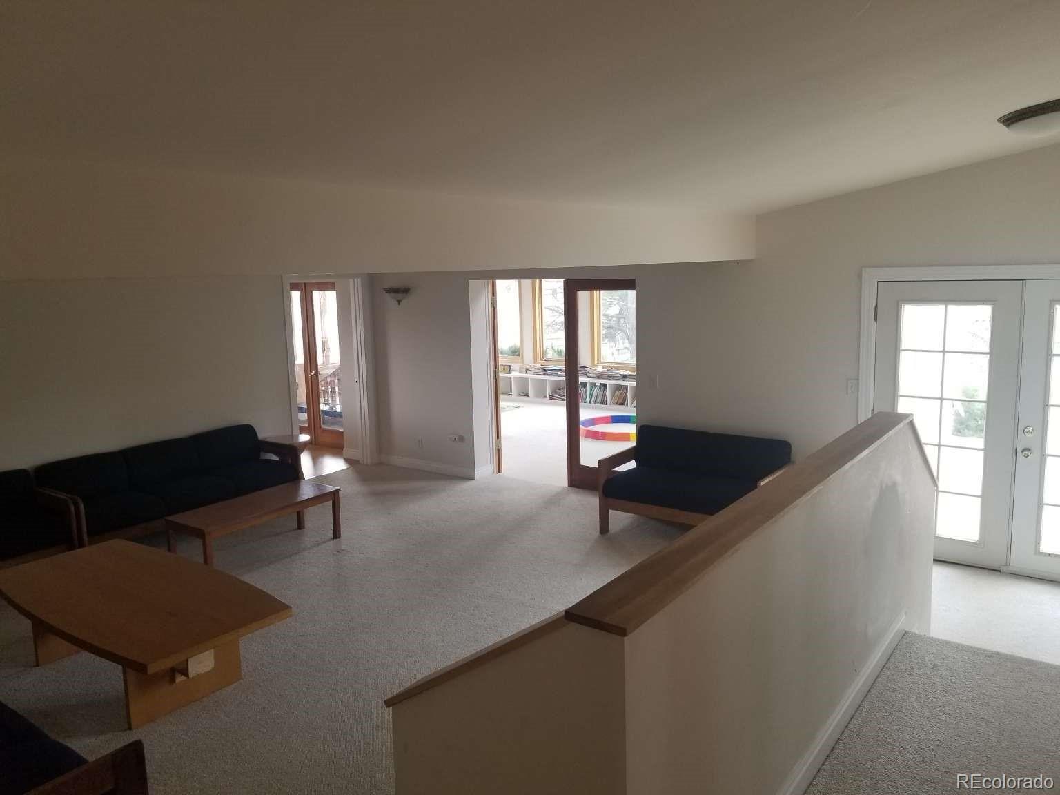 3800 Plateau Road Longmont, CO 80503 - Photo 11 of 12 a living room with furniture window and wooden floor