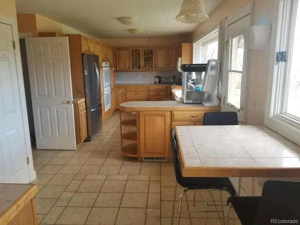 a kitchen with stainless steel appliances a refrigerator sink and cabinets