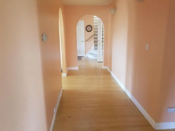 a view of a hallway with wooden floor