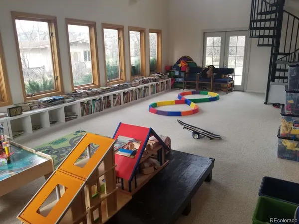 a living room with furniture and a floor to ceiling window