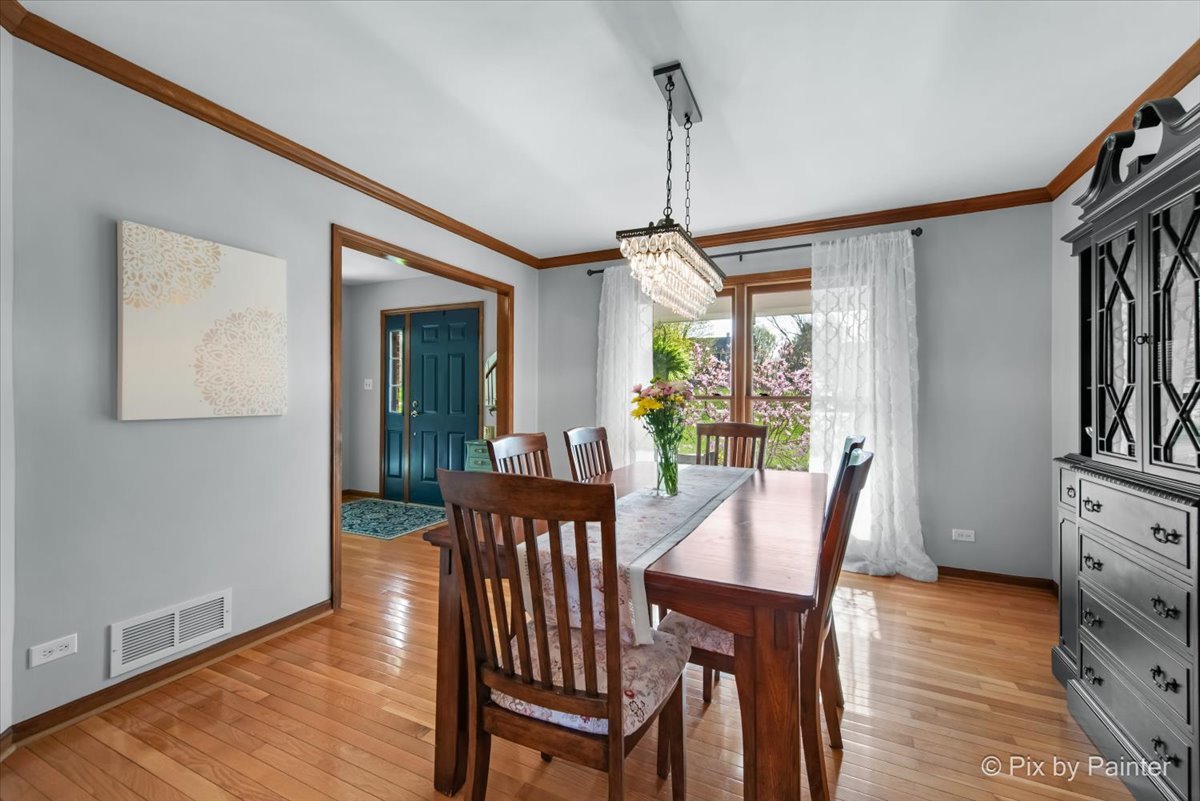 3910 Tecoma Drive Crystal Lake, IL 60012 - Photo 16 of 54 a view of a dining room with furniture window and wooden floor