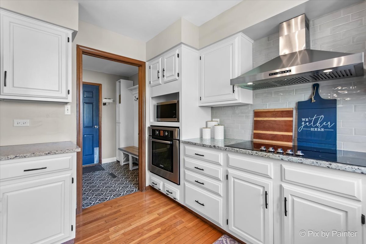 3910 Tecoma Drive Crystal Lake, IL 60012 - Photo 22 of 54 a kitchen with white cabinets and appliances