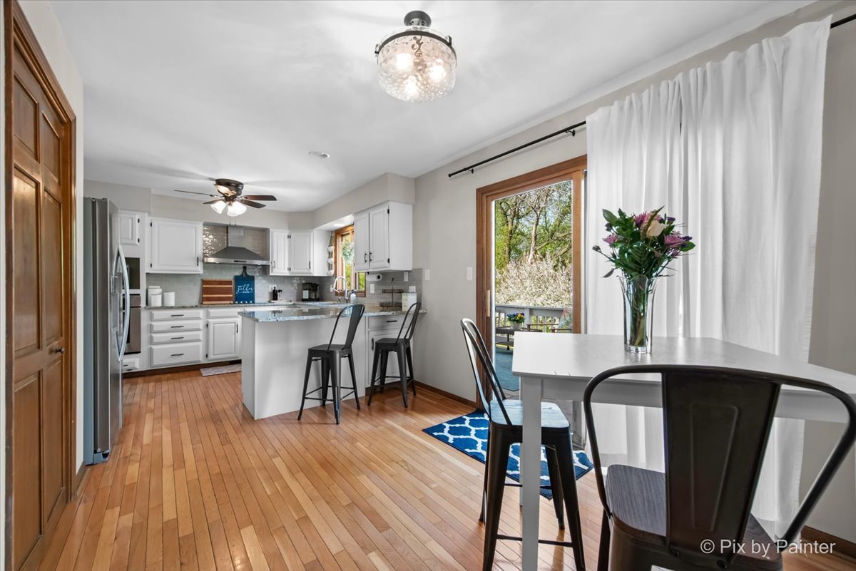 3910 Tecoma Drive Crystal Lake, IL 60012 - Photo 23 of 54 a view of a dining room with furniture window and wooden floor