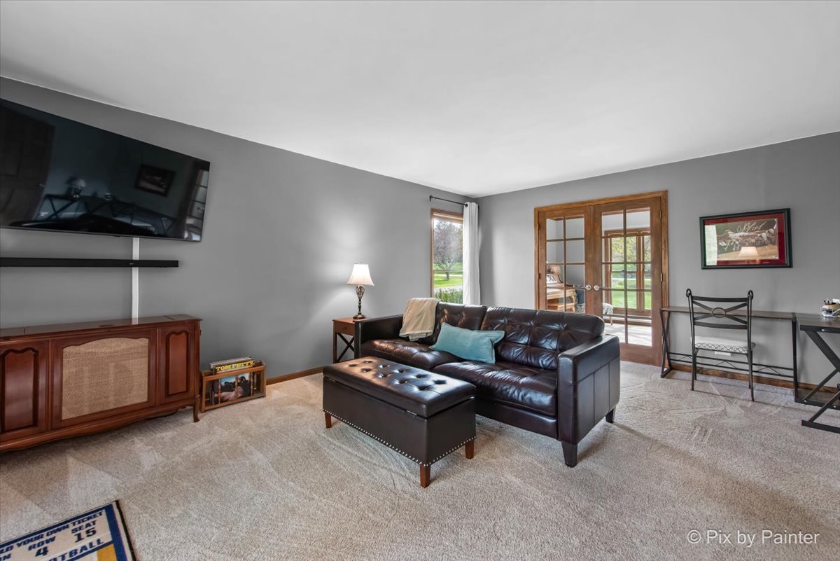 3910 Tecoma Drive Crystal Lake, IL 60012 - Photo 25 of 54 a living room with furniture and a flat screen tv