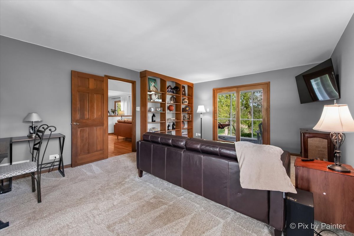 3910 Tecoma Drive Crystal Lake, IL 60012 - Photo 26 of 54 a living room with furniture a window and a flat screen tv