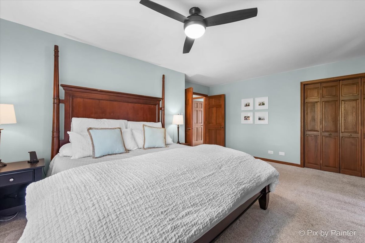 3910 Tecoma Drive Crystal Lake, IL 60012 - Photo 32 of 54 a bedroom with a large bed and a chandelier