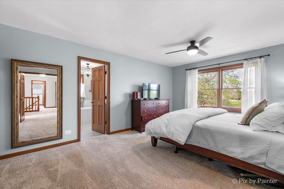 3910 Tecoma Drive Crystal Lake, IL 60012 - Photo 33 of 54 a bedroom with a bed and large windows