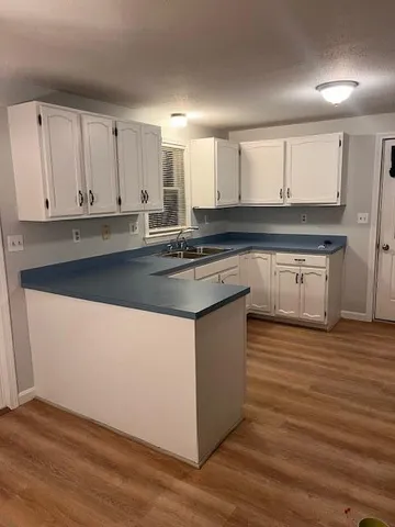 a kitchen with stainless steel appliances granite countertop a sink stove and cabinets