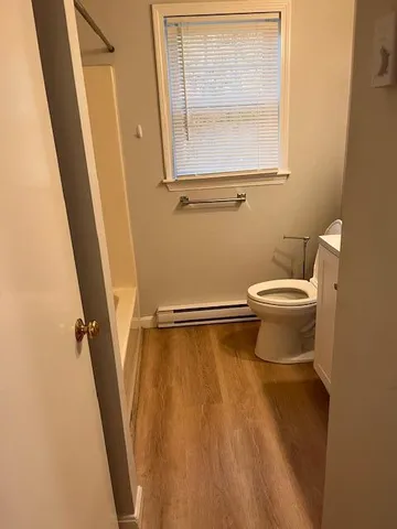 a white toilet sitting next to a small sink