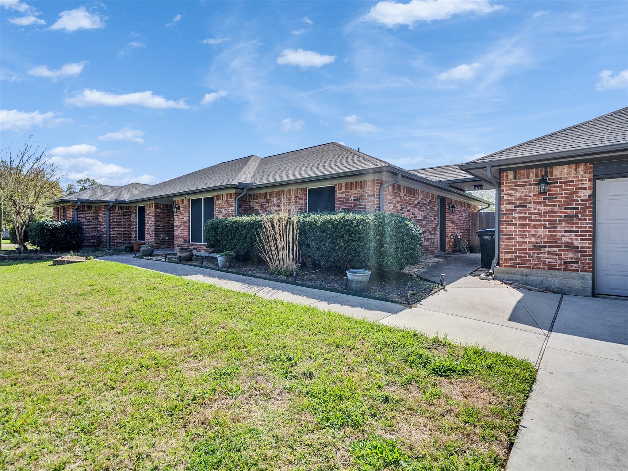 5036 Singletary Road Alvin, TX 77511 - Photo 1 of 35 Clean brick exterior with mature landscaping, a welcoming walkway, and a spacious driveway leading to the oversized garage.