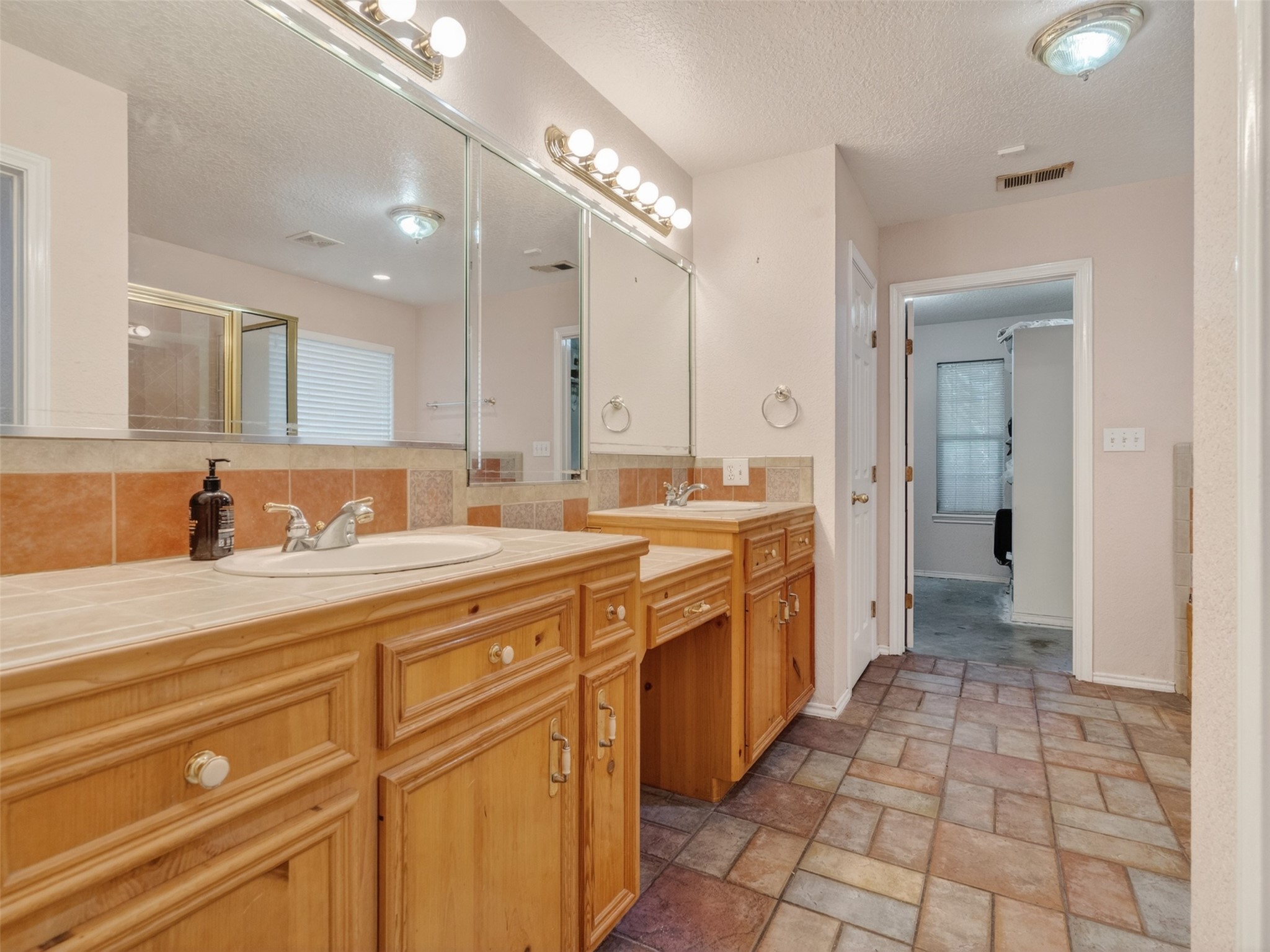 5036 Singletary Road Alvin, TX 77511 - Photo 11 of 35 Large primary bathroom featuring dual vanities, extensive counter space, and functional layout.