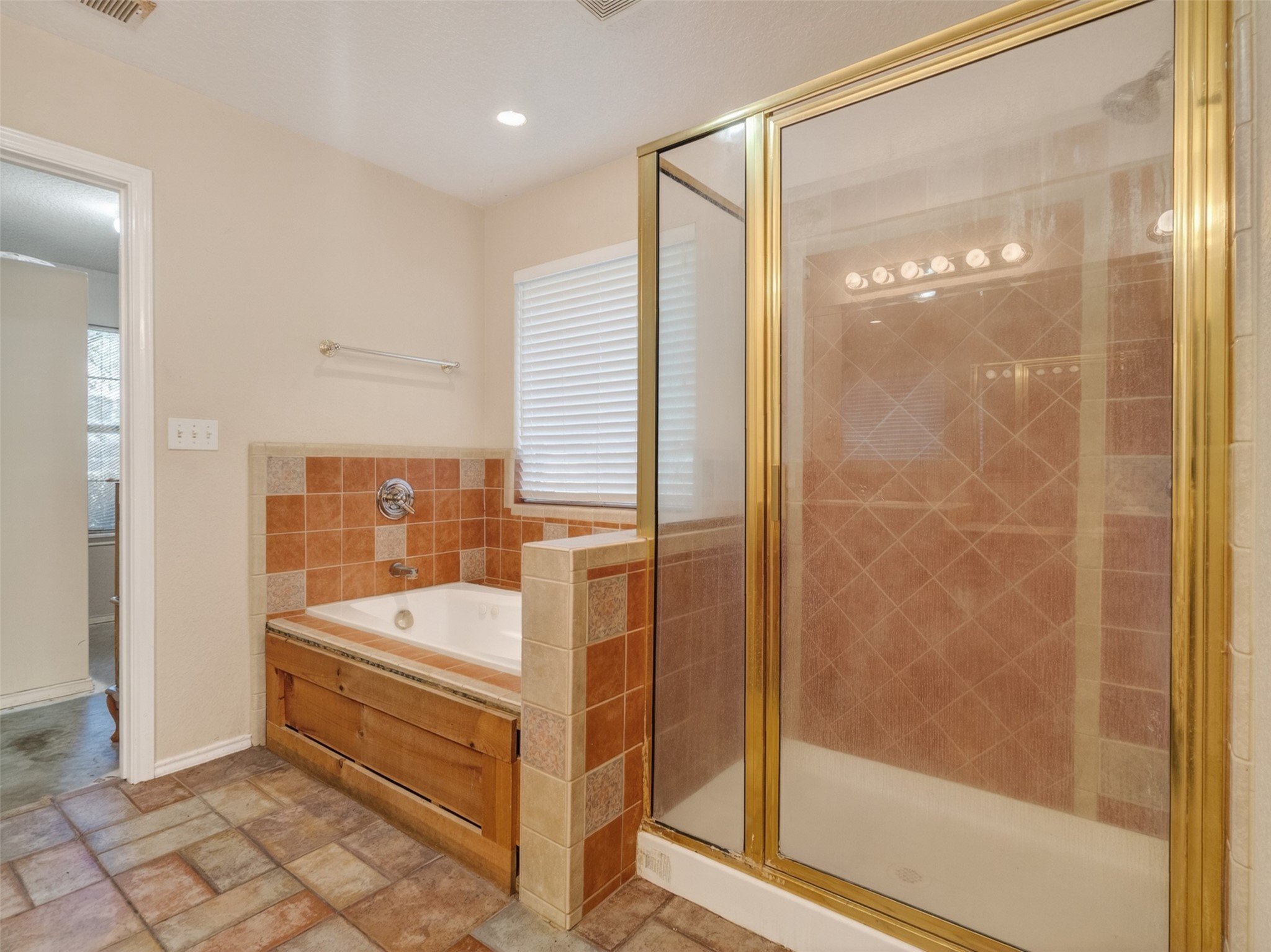 5036 Singletary Road Alvin, TX 77511 - Photo 12 of 35 Primary bathroom includes a soaking tub and separate shower for a relaxing retreat.