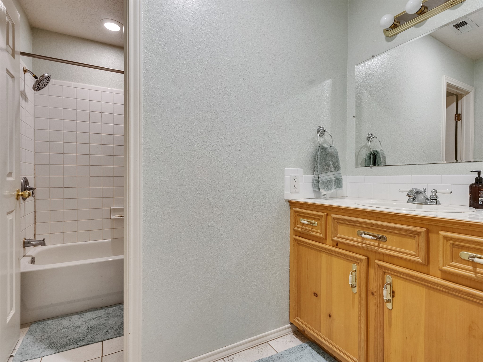 5036 Singletary Road Alvin, TX 77511 - Photo 19 of 35 Secondary bathroom with spacious vanity, ample storage, and easy access to tub/shower combo.