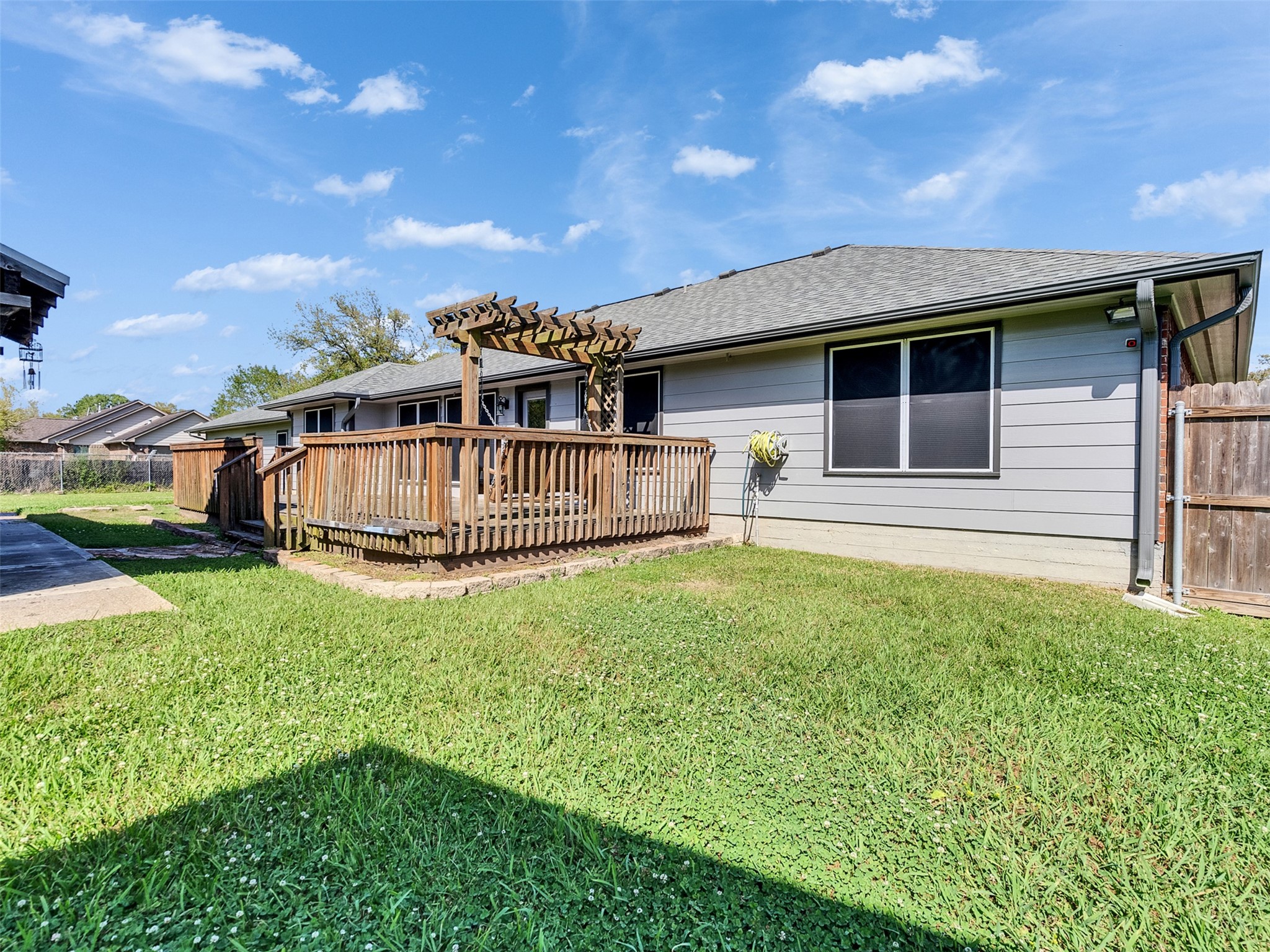 5036 Singletary Road Alvin, TX 77511 - Photo 24 of 35 Elevated deck with pergola overlooking spacious backyard—perfect for outdoor gatherings and relaxation.