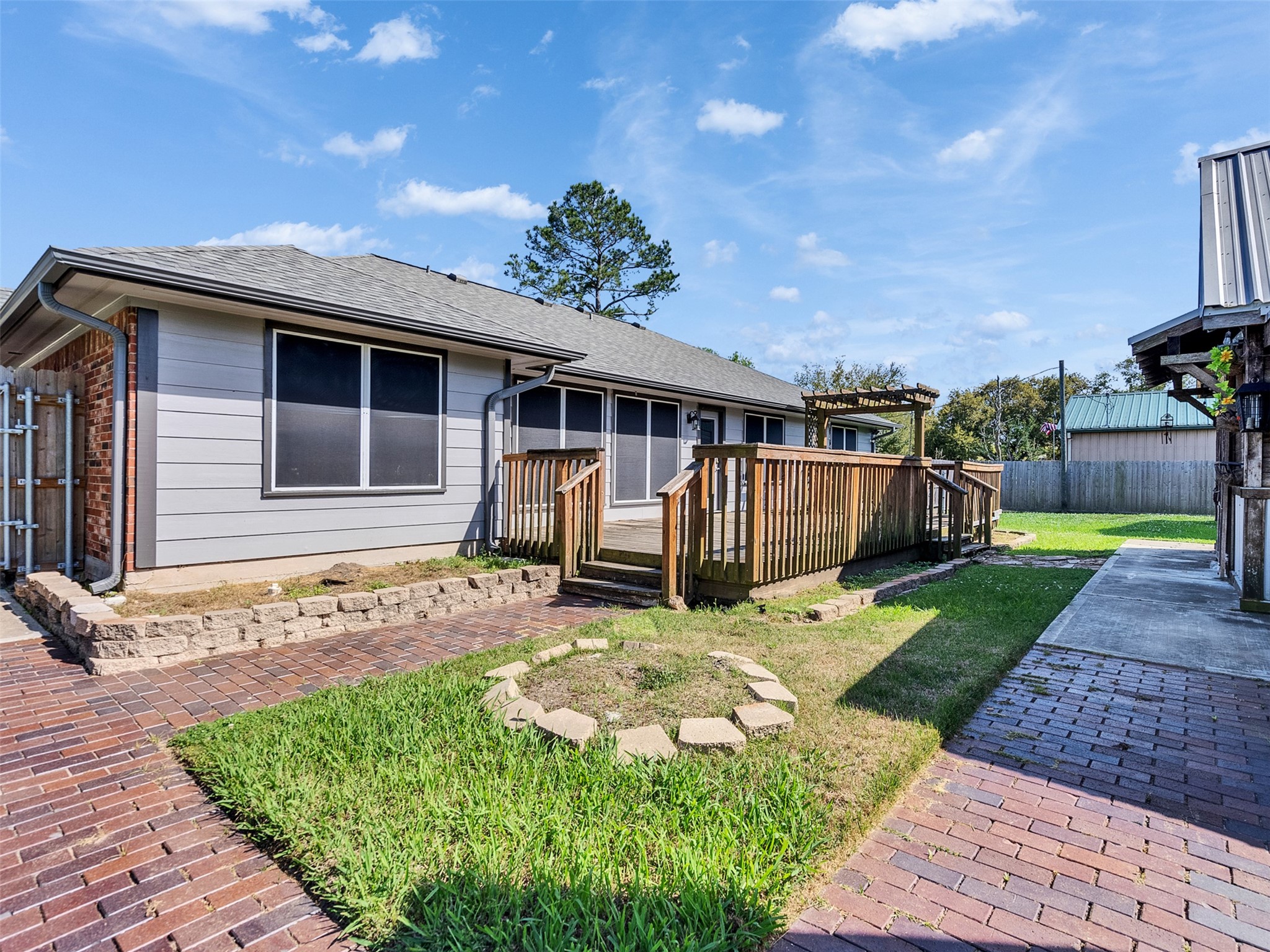 5036 Singletary Road Alvin, TX 77511 - Photo 25 of 35 Beautifully designed outdoor space featuring brick pathways, deck access, and seamless flow between home and entertaining areas.