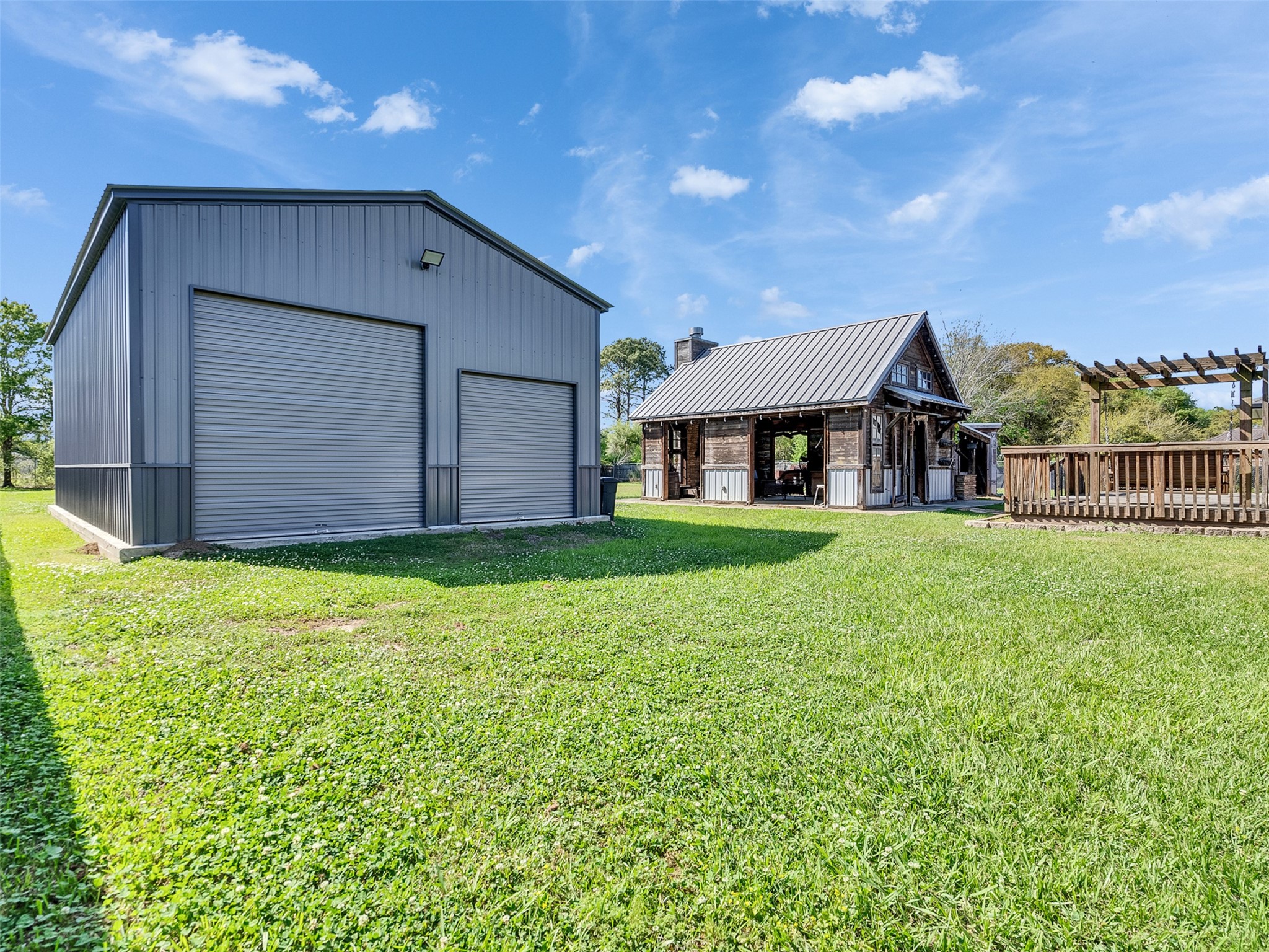 5036 Singletary Road Alvin, TX 77511 - Photo 29 of 35 Impressive property setup featuring large workshop and separate outdoor kitchen, ideal for hobbies, storage, or entertaining.