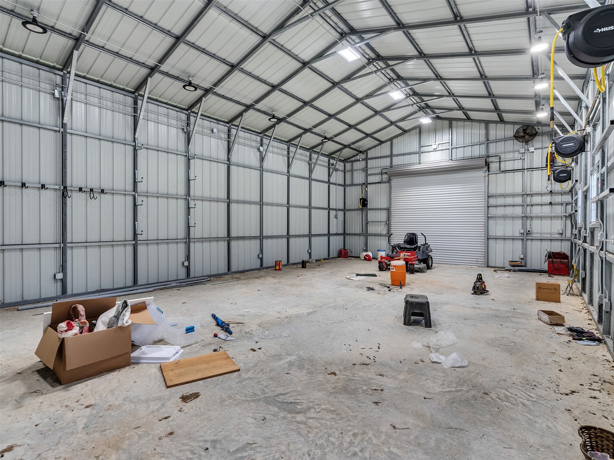 5036 Singletary Road Alvin, TX 77511 - Photo 30 of 35 Expansive workshop with high ceilings and large roll-up doors—perfect for projects, equipment, or storage.