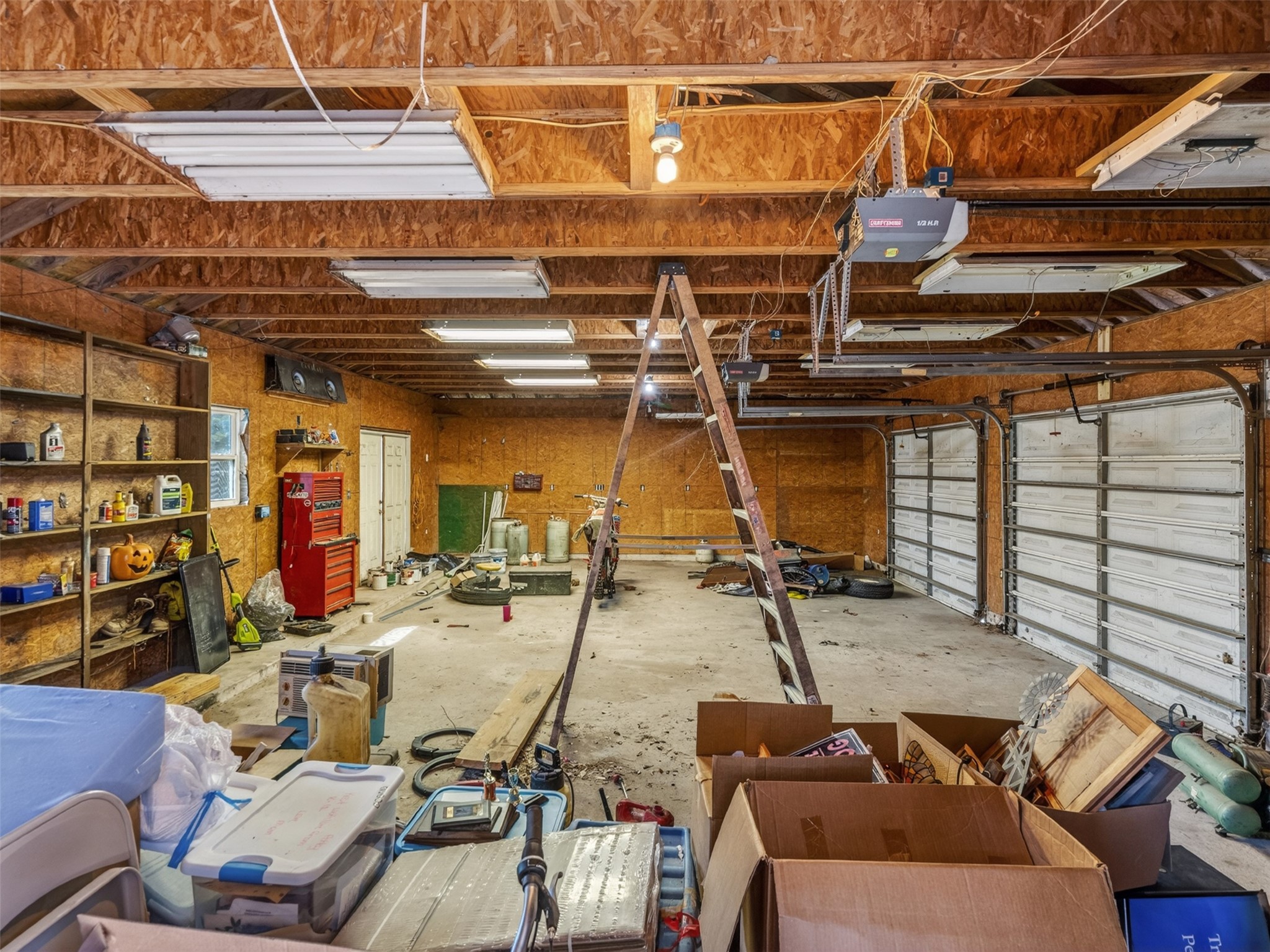 5036 Singletary Road Alvin, TX 77511 - Photo 31 of 35 Oversized garage/workspace with high ceilings and ample room for vehicles, tools, or hobby space.