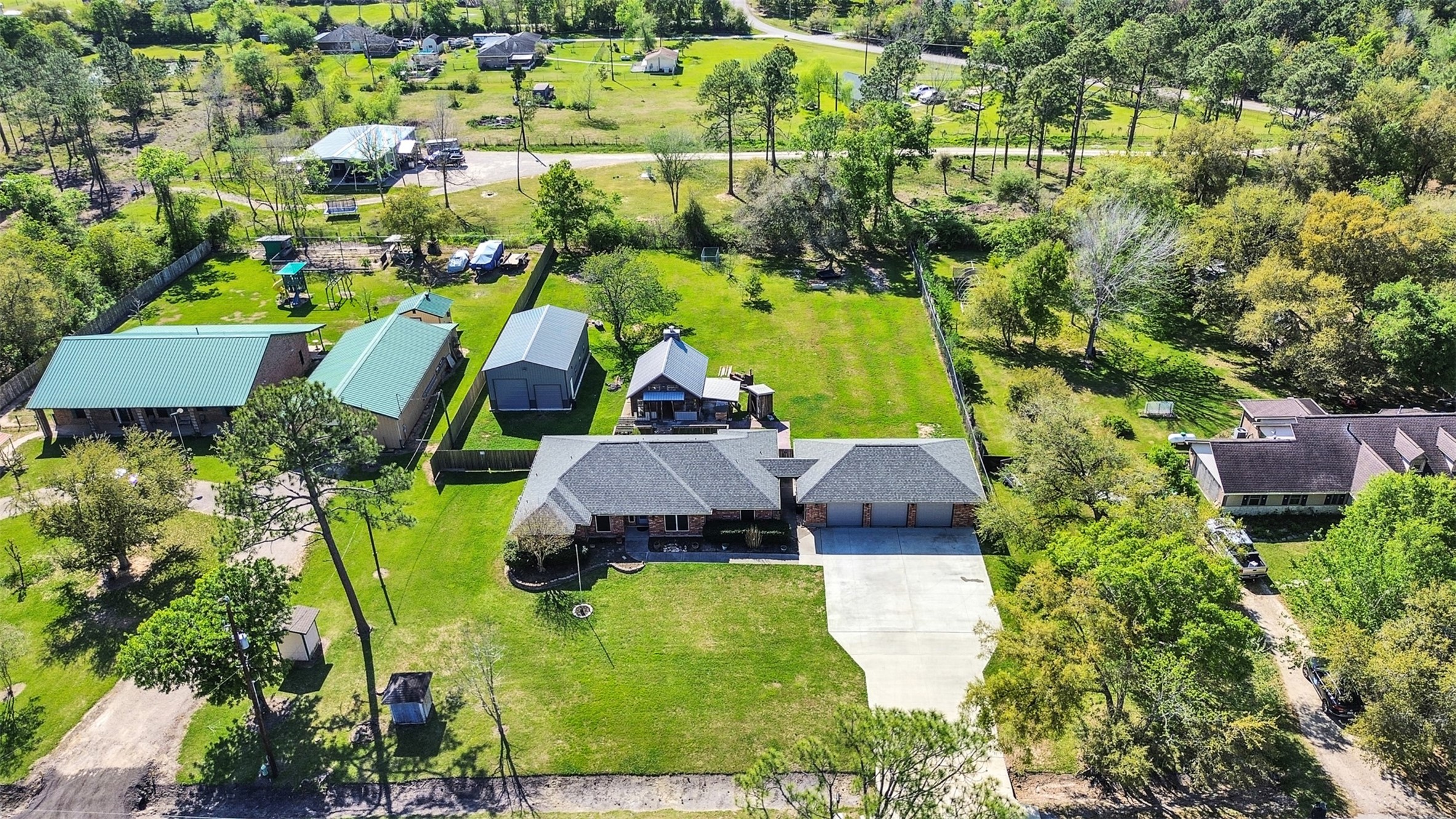 5036 Singletary Road Alvin, TX 77511 - Photo 32 of 35 Beautiful aerial view of the property showcasing the home, expansive driveway, and full acre lot with workshop and outdoor living space.