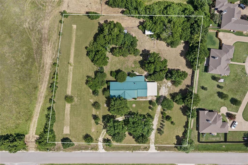 440 Williams Road Lorena, TX 76655 - Photo 16 of 19 Expansive property featuring a central residence with a teal-colored roof, surrounded by mature trees and open green spaces