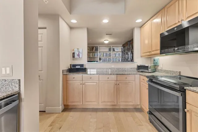 a room with lots of furniture and a book shelf