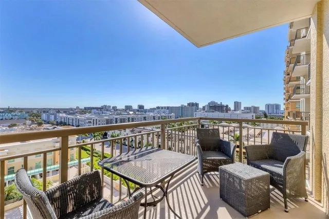 a swimming pool with outdoor seating and a yard