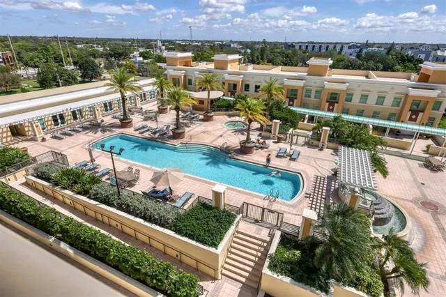 a view of a swimming pool with outdoor seating