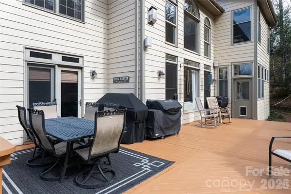 a view of a patio with table and chairs and potted plants