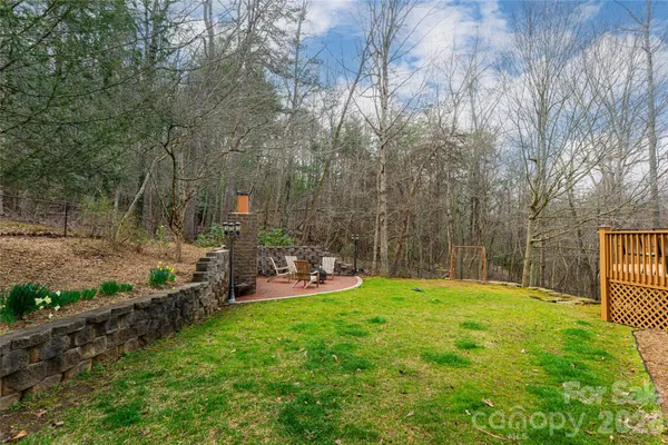 a backyard of a house with table and chairs