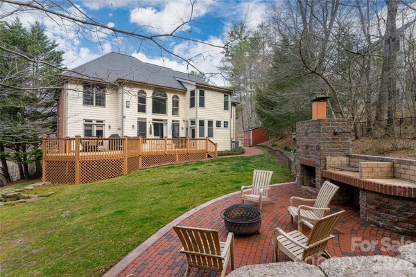 a view of house with backyard and outdoor seating