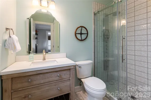 a bathroom with a toilet a sink and mirror