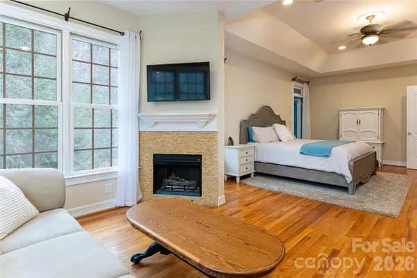 a living room with a bed furniture and a fireplace