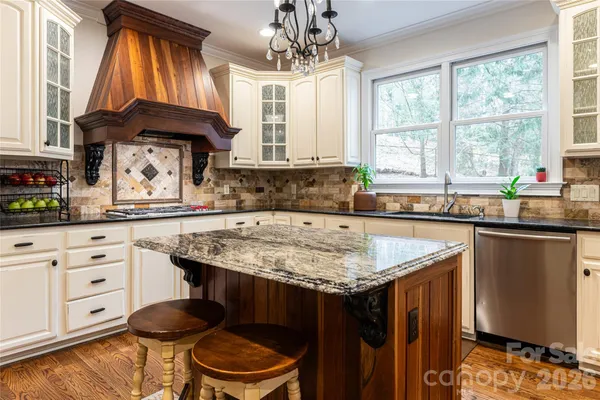 a kitchen with a sink a window and cabinets