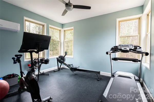 a room with gym equipment and windows
