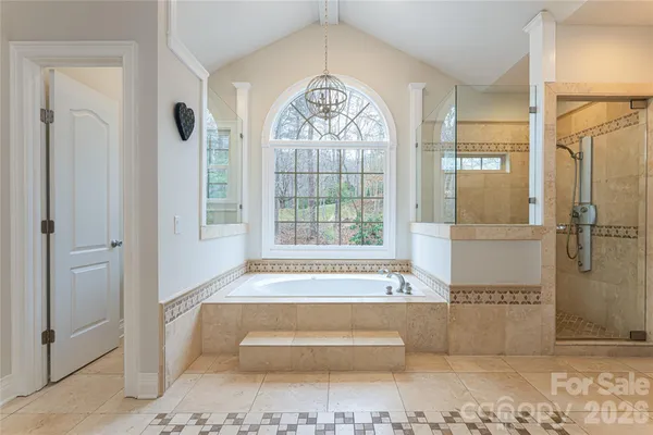 a bathroom with a bathtub and a shower