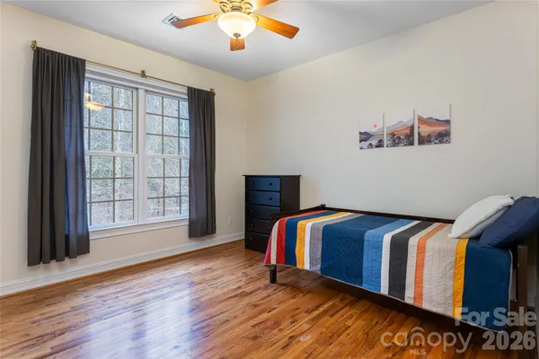 a bedroom with furniture and wooden floor
