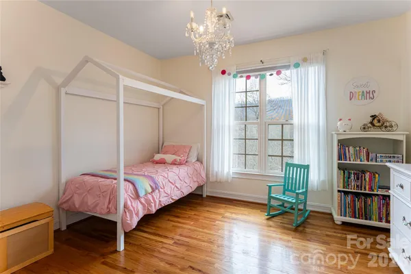 a bedroom with bed and a book shelf