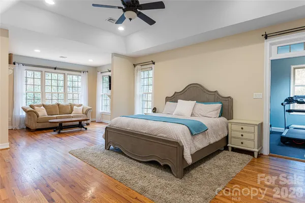 a bedroom with a bed couch and a window