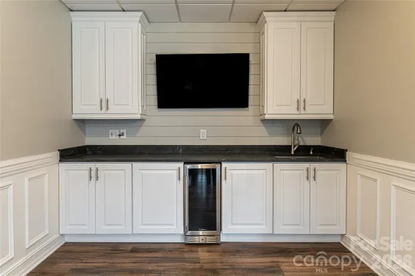 a kitchen with granite countertop white cabinets and sink