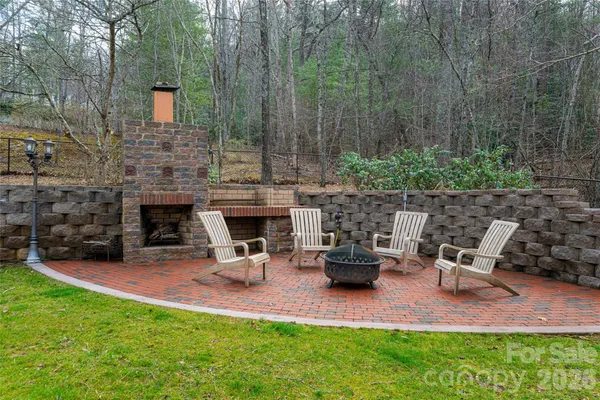 a view of a backyard with couches table and chairs and potted plants